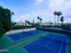Overhead view of well maintained tennis courts surrounded by palm trees at 10113 E Topaz Dr, Scottsdale, AZ 85258
