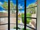 Window view showcases lush landscaping and fountain of the home's exterior at 10113 E Topaz Dr, Scottsdale, AZ 85258