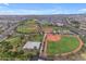 Aerial view of a community park with baseball fields, playground, and green spaces at 10425 E Corbin Ave, Mesa, AZ 85212