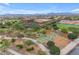 Aerial view of a community featuring a school, park, and athletic fields under a blue sky at 10425 E Corbin Ave, Mesa, AZ 85212