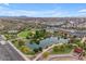 Aerial view of a community park featuring a pond, green space, and walking paths at 10425 E Corbin Ave, Mesa, AZ 85212