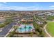 Aerial view of community pool, surrounding buildings, palm trees, and meticulously landscaped common areas at 10425 E Corbin Ave, Mesa, AZ 85212