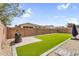 Backyard showcasing a synthetic grass area and grill, perfect for outdoor gatherings and low-maintenance landscaping at 10425 E Corbin Ave, Mesa, AZ 85212