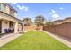 Expansive backyard featuring synthetic grass area, hardscape border, BBQ, and a private block wall at 10425 E Corbin Ave, Mesa, AZ 85212