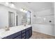 Well-lit bathroom features a double sink vanity with modern fixtures and a large mirror at 10425 E Corbin Ave, Mesa, AZ 85212