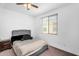Comfortable bedroom features a plush bed, ceiling fan, and bright natural light at 10425 E Corbin Ave, Mesa, AZ 85212