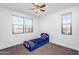 bedroom with blue bed, two windows and plenty of space at 10425 E Corbin Ave, Mesa, AZ 85212
