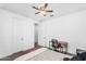 Well-lit bedroom with ceiling fan, desk, chair, and neutral decor at 10425 E Corbin Ave, Mesa, AZ 85212