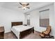 Bedroom with ceiling fan, windows, chair and queen sized bed at 10425 E Corbin Ave, Mesa, AZ 85212