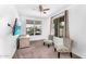 Spare bedroom with two chairs, a desk, large windows and a ceiling fan at 10425 E Corbin Ave, Mesa, AZ 85212