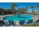 A beautiful community pool with lounge chairs and palm trees, perfect for relaxation at 10425 E Corbin Ave, Mesa, AZ 85212