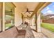 Covered patio with ceiling fans, brick pavers, outdoor seating, and view of backyard with artificial grass at 10425 E Corbin Ave, Mesa, AZ 85212