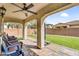 Inviting covered patio with ceiling fan, brick pavers, and comfortable seating overlooking the backyard at 10425 E Corbin Ave, Mesa, AZ 85212