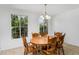 Bright dining room features a wooden table with six chairs and lots of natural light from two windows at 10425 E Corbin Ave, Mesa, AZ 85212