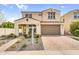 Charming two-story home featuring a welcoming front porch, desert landscaping, and a two-car garage at 10425 E Corbin Ave, Mesa, AZ 85212