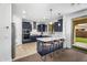 Modern kitchen with stainless appliances, breakfast bar, and tile floors, flowing into a carpeted living space at 10425 E Corbin Ave, Mesa, AZ 85212