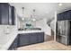 Modern kitchen with stainless steel appliances and an island that overlooks a bright and open living space at 10425 E Corbin Ave, Mesa, AZ 85212