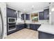 Bright kitchen featuring stainless steel appliances, a breakfast bar, and modern fixtures for a stylish look at 10425 E Corbin Ave, Mesa, AZ 85212