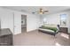 The main bedroom boasts a ceiling fan and is located near the ensuite bathroom and living room at 10425 E Corbin Ave, Mesa, AZ 85212