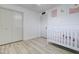 Well-lit bedroom with a white crib, closet, and modern décor, designed for comfort and style at 1059 E 9Th Ave, Mesa, AZ 85204