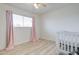 Cozy bedroom featuring wood floor, large window with natural light, and pink curtains at 1059 E 9Th Ave, Mesa, AZ 85204