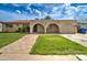 Charming single-story home featuring a well-maintained front yard and a unique arched carport at 1059 E 9Th Ave, Mesa, AZ 85204