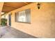A covered front porch features a secure entry door and a view of the textured exterior wall at 1059 E 9Th Ave, Mesa, AZ 85204