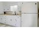 Functional kitchen featuring ample white cabinetry, a double sink, and modern appliances with convenient layout at 1059 E 9Th Ave, Mesa, AZ 85204