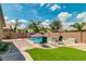 Inviting backyard pool area with lounge chairs, artificial grass, and privacy fencing at 1072 E Jade Dr, Chandler, AZ 85286