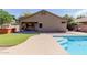 Scenic backyard with a covered patio, hot tub, artificial grass, and sparkling pool area at 1072 E Jade Dr, Chandler, AZ 85286