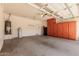 Spacious garage featuring abundant cabinet storage, utility sink, and well-lit area at 1072 E Jade Dr, Chandler, AZ 85286