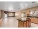 Open kitchen with granite countertops, stainless appliances, and spacious tile flooring at 1072 E Jade Dr, Chandler, AZ 85286