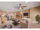 Spacious living room with a ceiling fan, lovely furniture, and an open floor plan to the kitchen at 1072 E Jade Dr, Chandler, AZ 85286