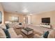 Bright living room with large windows, a comfortable seating arrangement, and a modern entertainment center at 1072 E Jade Dr, Chandler, AZ 85286