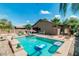 Backyard featuring sparkling pool, lush landscaping, patio area, and privacy fencing at 1072 E Jade Dr, Chandler, AZ 85286