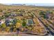Aerial view of an exclusive community with tennis court, landscaping, and stunning mountain views at 10799 E Florence Way, Scottsdale, AZ 85262