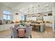 Bright, open kitchen features a large island with seating and adjacent dining area, perfect for entertaining at 10799 E Florence Way, Scottsdale, AZ 85262
