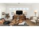 Inviting living room featuring a comfortable seating area, wooden accents, and natural light at 10799 E Florence Way, Scottsdale, AZ 85262
