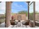 Cozy patio setting with comfortable seating, decorative wall features, and views of the surrounding desert landscape at 10799 E Florence Way, Scottsdale, AZ 85262