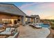 Outdoor patio with lounge seating, outdoor dining, and a pool at 10799 E Florence Way, Scottsdale, AZ 85262