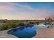 Backyard pool with desert mountain views at dusk at 10799 E Florence Way, Scottsdale, AZ 85262