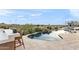 Desert home outdoor pool area with chairs, waterfall feature, and desert views at 10799 E Florence Way, Scottsdale, AZ 85262