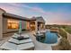 Backyard pool with lounge chairs and outdoor bar area at 10799 E Florence Way, Scottsdale, AZ 85262