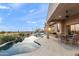 Outdoor pool area with patio, landscaping, dining set, and scenic desert views at 10799 E Florence Way, Scottsdale, AZ 85262
