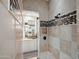 Modern shower features custom tilework, a frameless glass door, and a convenient built-in shower bench at 10799 E Florence Way, Scottsdale, AZ 85262