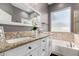 Bathroom featuring granite counters and a soaking tub at 11163 E Laurel Ln, Scottsdale, AZ 85259