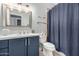 Well-lit bathroom featuring a blue vanity, neutral walls, and a granite countertop at 11163 E Laurel Ln, Scottsdale, AZ 85259