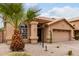 Single-story home featuring desert landscaping and a two-car garage at 11163 E Laurel Ln, Scottsdale, AZ 85259