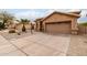 Single-story home featuring desert landscaping, driveway, and a two-car garage at 11163 E Laurel Ln, Scottsdale, AZ 85259