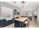 Modern kitchen with an island, lighting fixtures, and an open layout that flows into the living room at 11163 E Laurel Ln, Scottsdale, AZ 85259